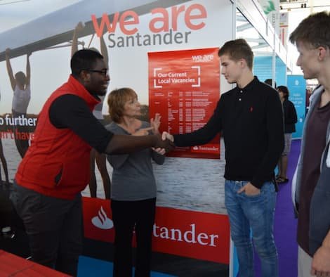 interpreter with deaf jobseekers meeting a recruiter at a jobs fair