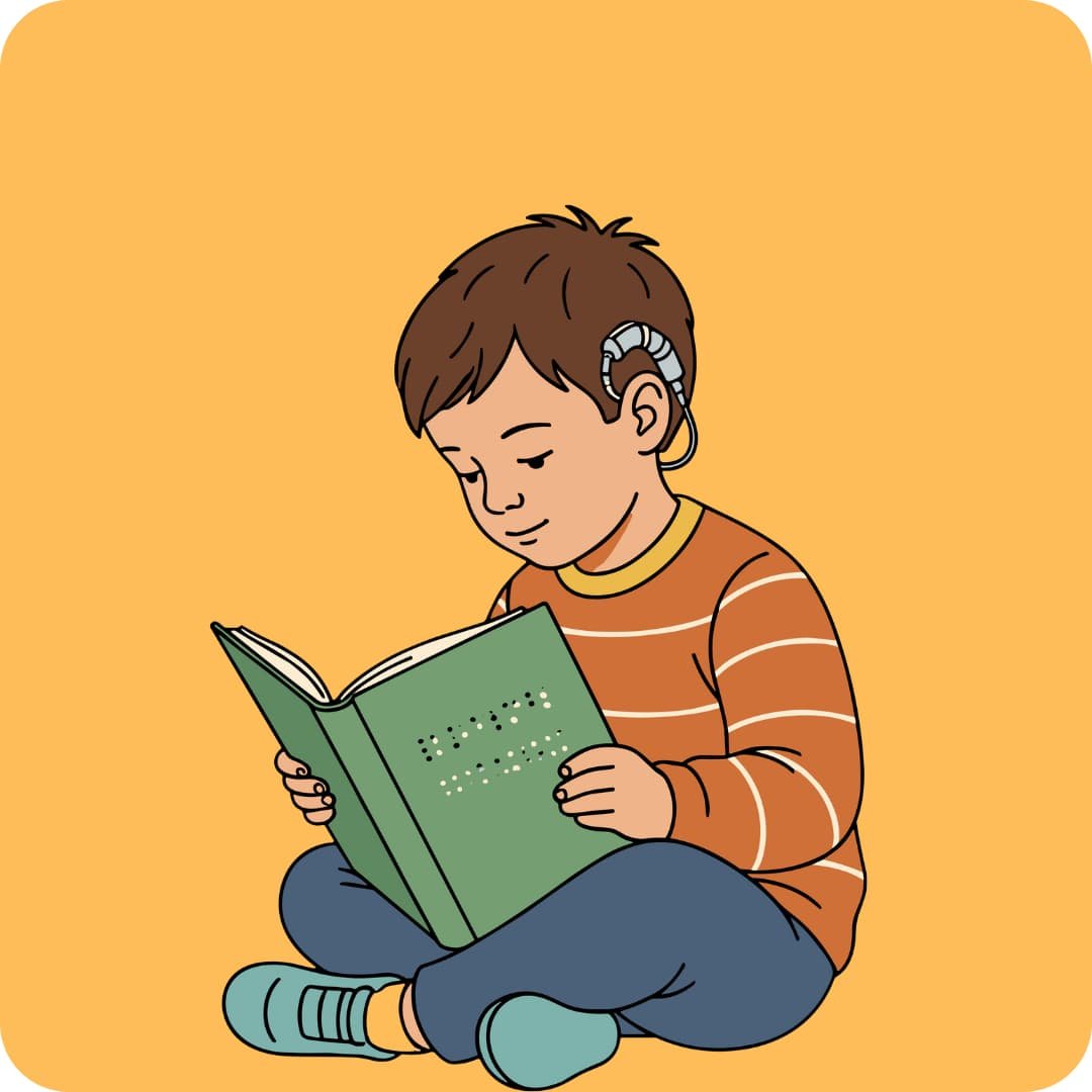 deaf boy with cochlear sitting and reading a book